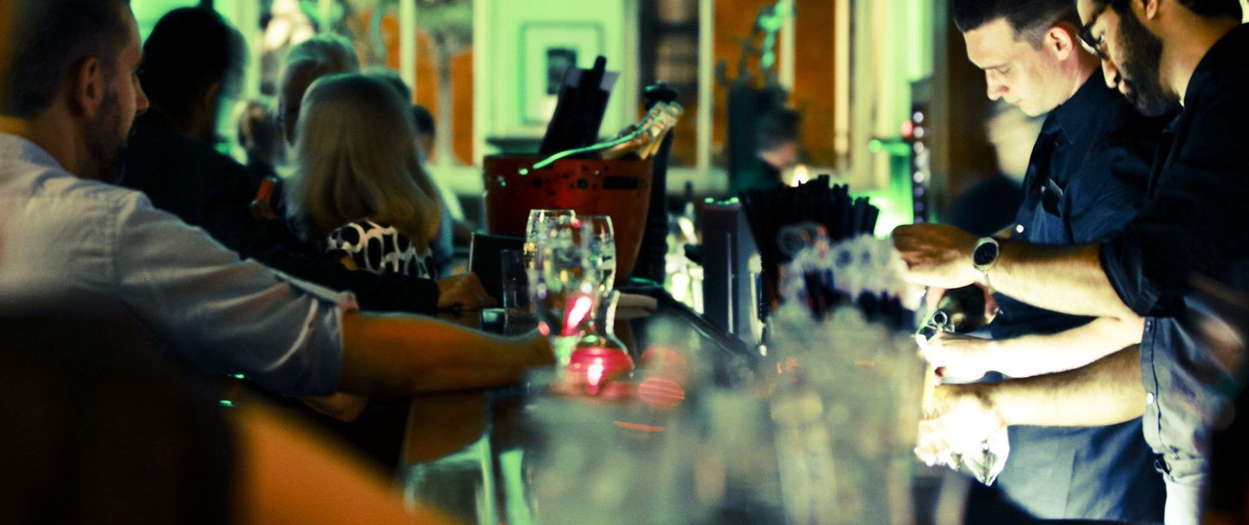 Bartenders and guests at bar